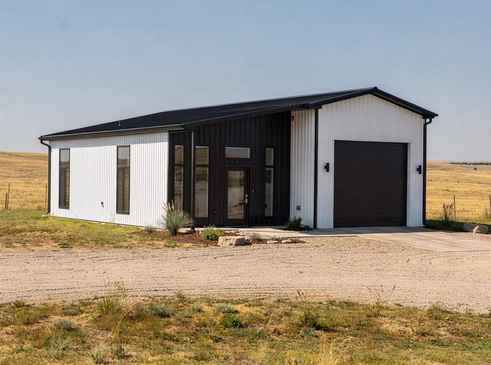 Steel-framed barndominium concept rendering with attached shop and RV bay