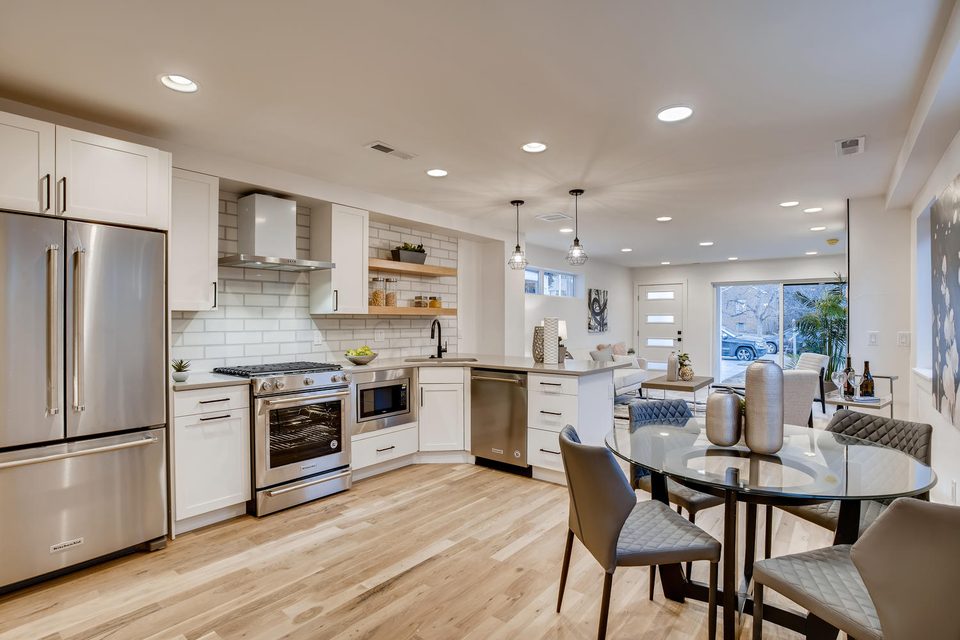 Josephine kitchen — white shaker cabinets, subway tile, open to living